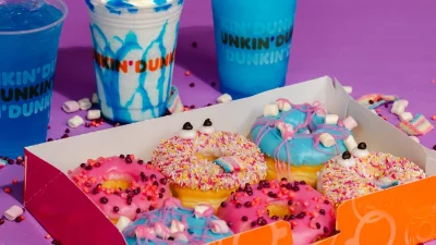 Dunkin' storefront featuring signature orange and pink branding with a welcoming entrance for coffee and doughnut lovers.
