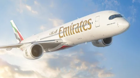 Emirates Airlines aircraft flying above the clouds, representing luxury air travel and premium flight experiences.