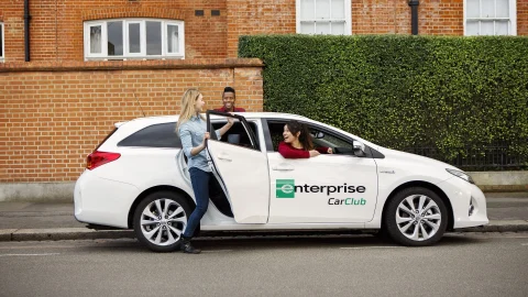 Enterprise Car Club vehicle parked in a modern UK city centre, representing convenient car sharing and rental services.