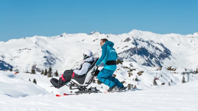 Family enjoying a scenic ski holiday in the French Alps with Erna Low, featuring snow-covered mountain slopes.