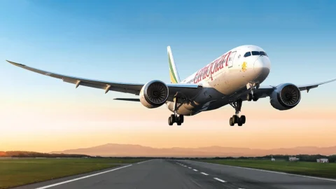 Ethiopian Airlines passenger aircraft taxiing at an international airport terminal for flight departures.