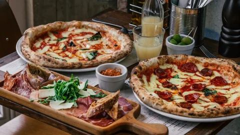 Franco Manca sourdough pizza served in a modern restaurant setting, showcasing authentic Italian dining and menu deals.