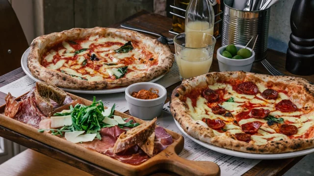 Franco Manca sourdough pizza served in a modern restaurant setting, showcasing authentic Italian dining and menu deals.
