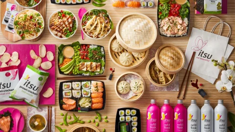 Itsu restaurant interior featuring healthy Asian-inspired takeaway meals and fresh sushi on display for customers.