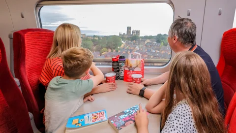 LNER Azuma train travelling through the British countryside, representing comfortable rail travel and holiday journeys.