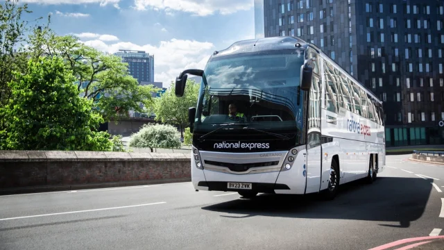 National Express coach travelling on a UK motorway, representing affordable coach travel and transport services.