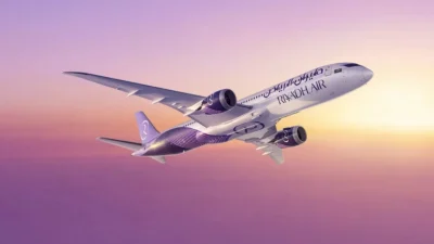 Riyadh Air aircraft exterior view showcasing the modern livery and branding at an international airport terminal.