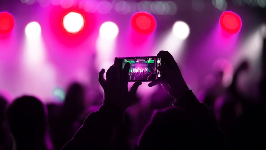 See Tickets brand logo and event booking interface on a digital screen for purchasing concert and theatre tickets.