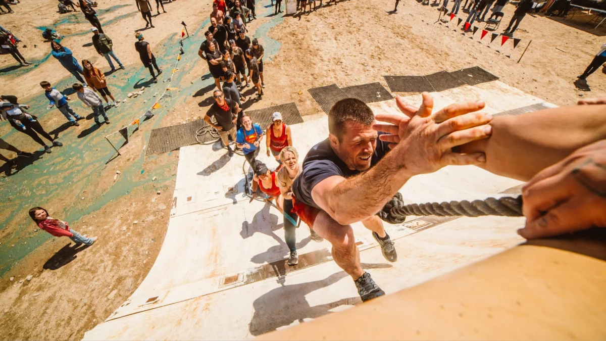 Participants tackling a challenging obstacle course at a Spartan Race event, showcasing endurance and fitness training.