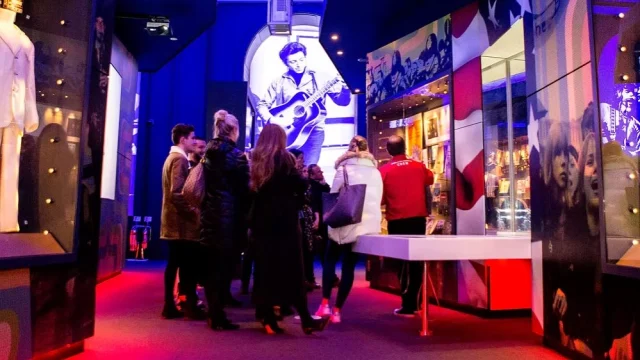 Visitors exploring interactive music exhibits at The British Music Experience in Liverpool, UK.
