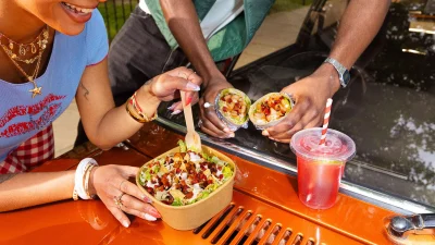 Freshly prepared Mexican tortilla wrap served in a branded Tortilla restaurant setting for a delicious meal deal.
