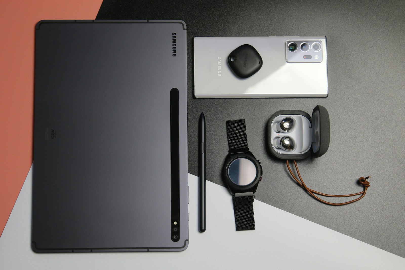 Samsung Galaxy ecosystem devices including smartphone, tablet, and smartwatch displayed on a clean, modern desk surface.