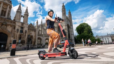 Voi electric scooter parked on a city street, representing sustainable urban travel and Voi brand transport solutions.