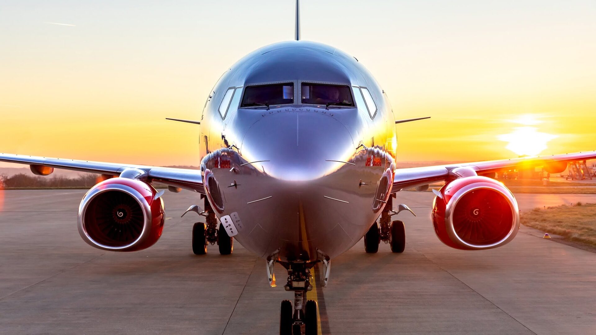 Jet2 passenger aircraft flying above the clouds, representing affordable holiday travel and flight bookings.