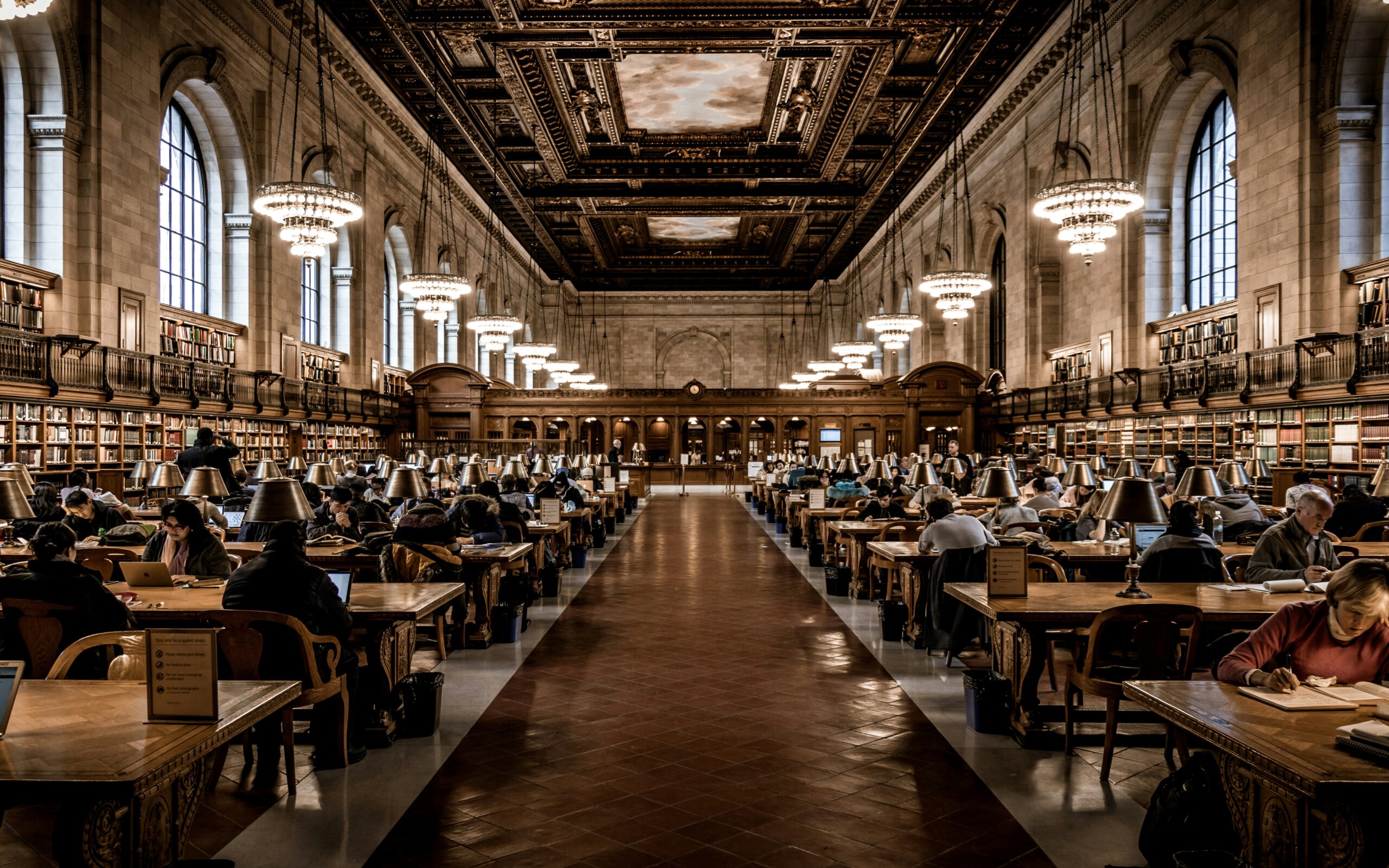 Readers studying at long oak tables in the Rose Main Reading Room of the New York Public Library