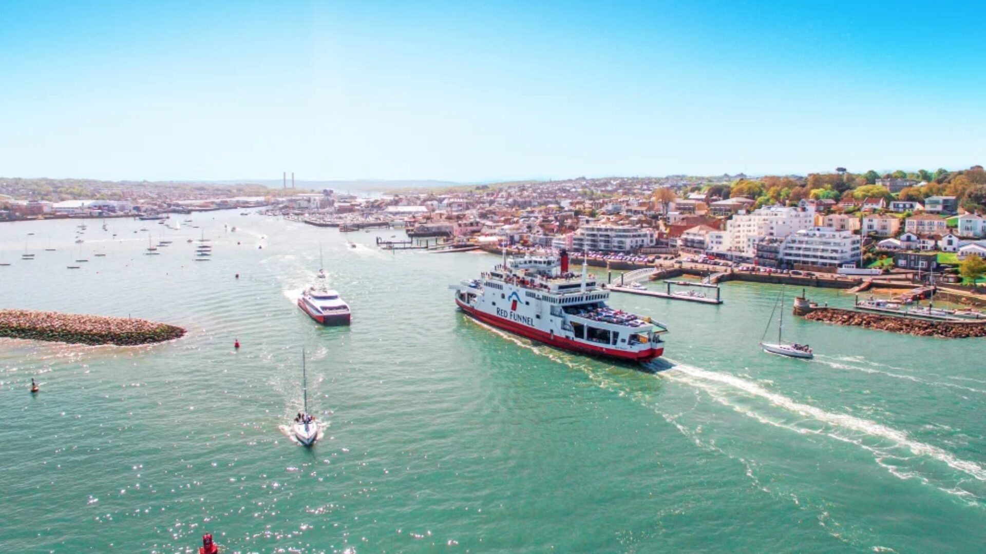 Red Funnel ferry travelling across the Solent towards the Isle of Wight, showcasing the iconic red ship livery.