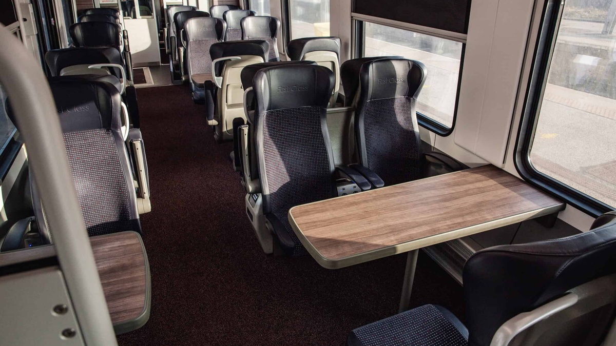 Greater Anglia First Class intercity carriage interior with leather seats and wood tables