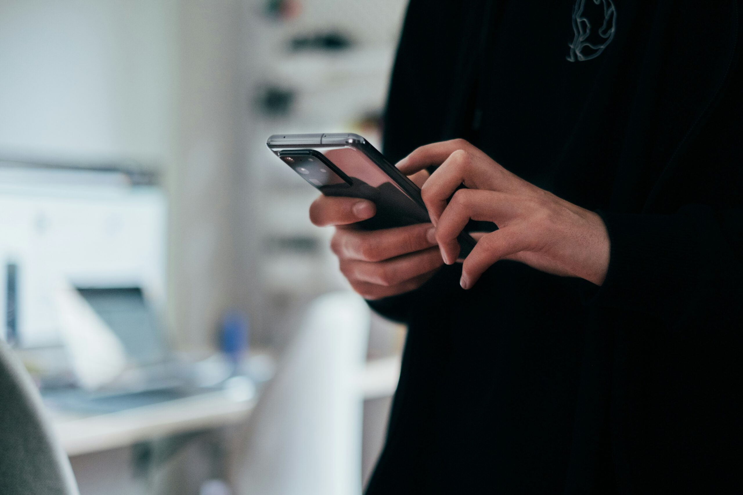 Person holding smartphone to practise language learning app exercises
