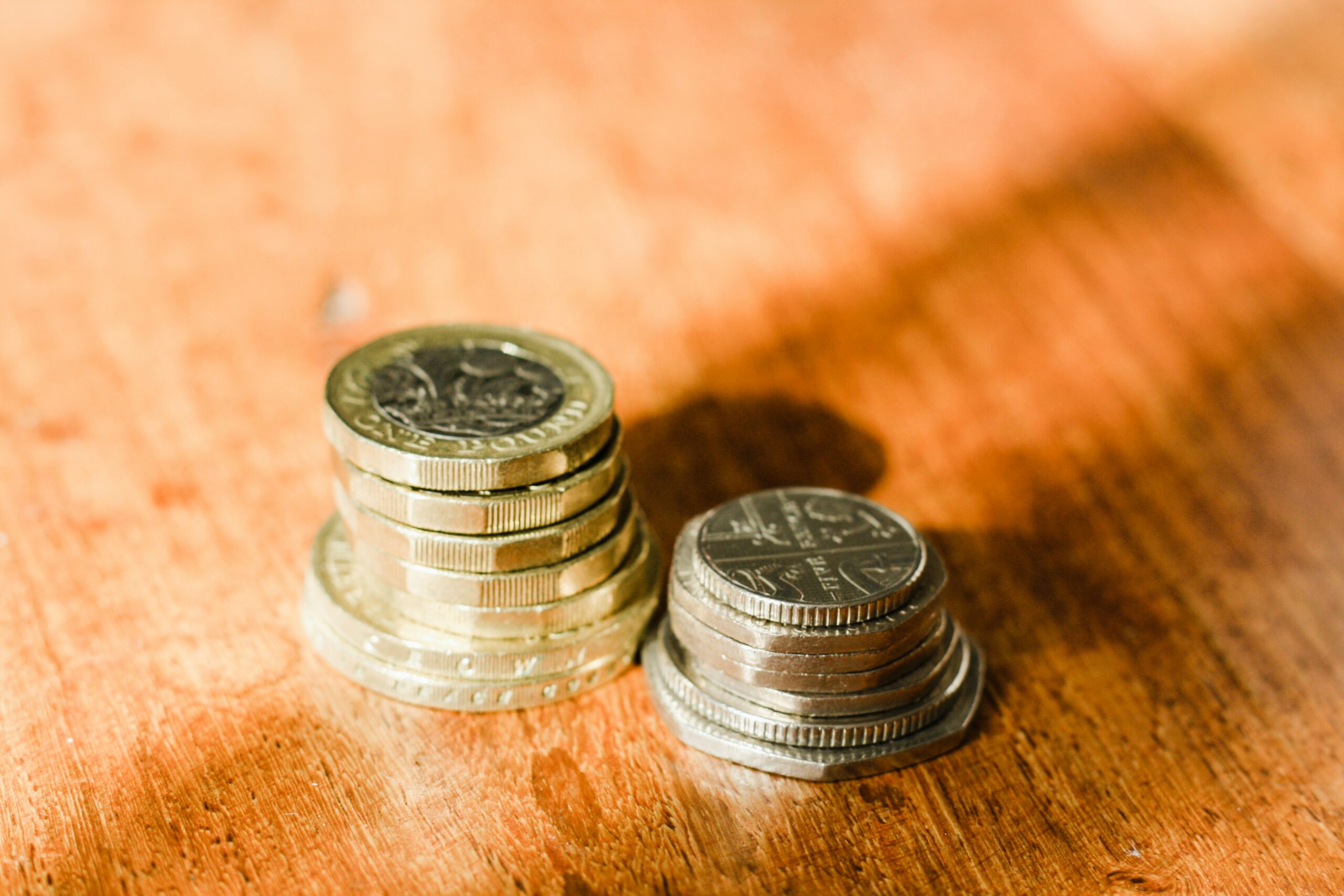 British one pound coins representing statutory minimum wage rates in the UK