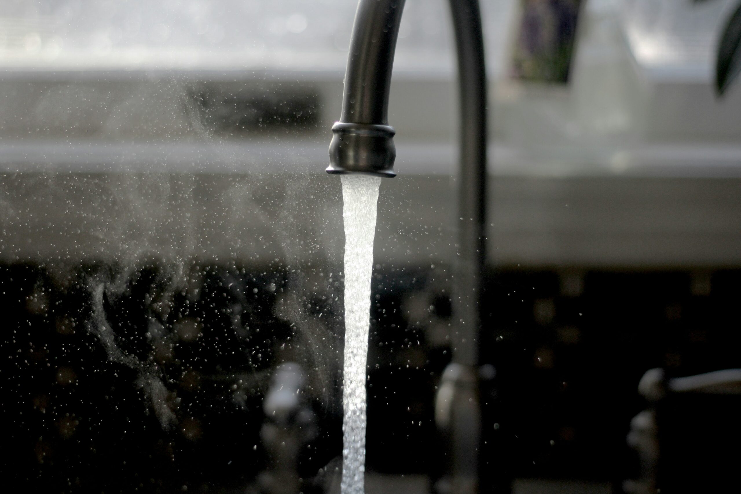 Clean water flowing from a kitchen tap representing UK water utility charges